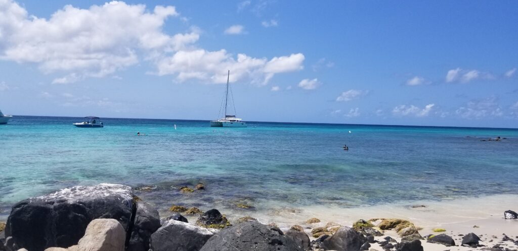 Warm travel destination Aruba. Sailboat off the shore.